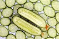 Cut lengthwise the cucumber on the background of sliced cucumber Royalty Free Stock Photo