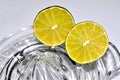 Cut lime citrus resting on glass juicer