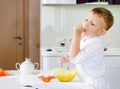 Cut little chef tasting his batter mixture