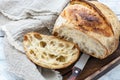 Cut a loaf of artisanal bread on sourdough.