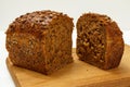 Cut loaf of bread on wooden cutting board on white background Royalty Free Stock Photo