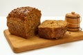 Cut loaf of bread on wooden cutting board on white background Royalty Free Stock Photo