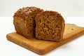 Cut loaf of bread on wooden cutting board on white background Royalty Free Stock Photo