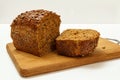 Cut loaf of bread on wooden cutting board on white background Royalty Free Stock Photo