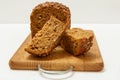 Cut loaf of bread on wooden cutting board on white background Royalty Free Stock Photo