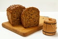 Cut loaf of bread on wooden cutting board on white background Royalty Free Stock Photo