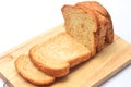 The cut loaf of bread on the wooden cutting board on the white background. Royalty Free Stock Photo