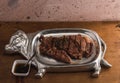 Cut of meat `Aguja norteÃÂ±a Sonora`, served on a silver plate in the shape of a cow 16