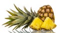 Cut off top of pineapple with leaves, next to slices isolated on white Royalty Free Stock Photo