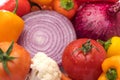 Cut onion and Vegetable Medley for salad with peppers, cauliflower, and tomatoes on white background. Health concept. Water Royalty Free Stock Photo