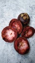 Cut open too ripe mangosteens against rustic white background