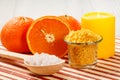 Cut orange, candle, wooden spoon and glass bowl with sea salt Royalty Free Stock Photo