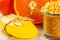 Cut orange, soap and glass bowl with yellow sea salt Royalty Free Stock Photo