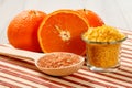 Cut orange, wooden spoon and glass bowl with sea salt Royalty Free Stock Photo