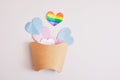 cut out colored paper hearts in packaging for fries on a gray background, transexual colors, lgbt pride concept