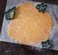 Cut Out Gingerbread Cookie In The Form Of A Christmas Tree, Star, Little Man, Hearts From Raw Dough On Parchment Baking Paper On A