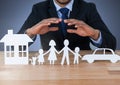 Cut out house family and car under protective hands Royalty Free Stock Photo