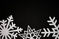 Cut out paper snowflakes on black background Royalty Free Stock Photo