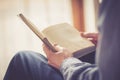 Senior man is reading a book at home, selective focus Royalty Free Stock Photo