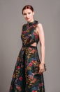Cut out waist midi dress in floral embroidery with black high heels. Ginger lady walking in studio with transparent handbag