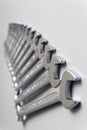 Cut-out wrenches horizontally placed from the biggest to the smallest in a row. Top view composition. Hand tool. Tools