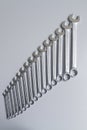 Cut-out wrenches horizontally placed from the biggest to the smallest in a row. Top view composition. Hand tool. Tools