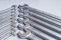 Cut-out wrenches horizontally placed from the biggest to the smallest in a row. Top view composition. Hand tool. Tools