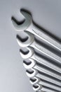 Cut-out wrenches horizontally placed from the biggest to the smallest in a row. Top view composition. Hand tool. Tools