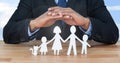 Cut outs of family under protective hands