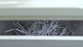 Cut paper falls into the container. Shredder destroys paper close-up. Shredder cuts paper into stripes. View of the Royalty Free Stock Photo