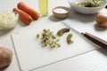 Cut pickled cucumbers and ingredients on white wooden table. Cooking vinaigrette salad