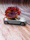 cut piece of berry eclair on toy car, delivery concept