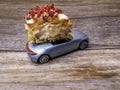 cut piece of berry eclair on toy car, delivery concept