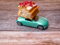 cut piece of berry eclair on toy car, delivery concept