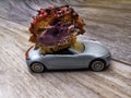 cut piece of berry eclair on toy car, delivery concept