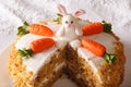 Cut a piece of carrot cake decorated with bunny close-up. horizontal Royalty Free Stock Photo