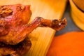 Cut pieces cooked guinea pig meat lying on wooden surface next to potatoes, tostados and bowl of salsa Royalty Free Stock Photo