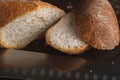 Cut into pieces fresh loaf of wheat bread. Slices of french baguette and knife. Close-up photo Royalty Free Stock Photo