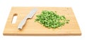 Cut in pieces green onion over cutting board Royalty Free Stock Photo