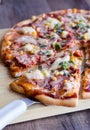 Cut on pieces pizza with sausage, chicken, corn and cheese Royalty Free Stock Photo