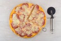 Cut pizza with sausage on cutting board and cutter Royalty Free Stock Photo