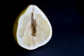 Cut pomello fruit with a juicy pulp, on a black background Royalty Free Stock Photo