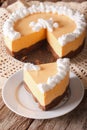 Cut pumpkin cheese cake decorated with whipped cream close-up. v Royalty Free Stock Photo