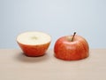 Cut red apple, top and bottom half, side by side Royalty Free Stock Photo