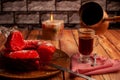 Cut red decorated donut on wooden table and coffee pot pouring on tea glass cup and on table Royalty Free Stock Photo