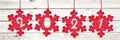 2021 cut in red fabric christmas ornaments hanging on panoramic planks background Royalty Free Stock Photo