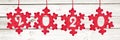 2020 cut in red fabric christmas ornaments hanging on panoramic white planks Royalty Free Stock Photo