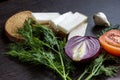 Cut red onions, tomato, dill, lard salo and garlic on wooden table Royalty Free Stock Photo