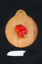 Cut red pepper on wooden board and black background Royalty Free Stock Photo