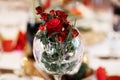 Cut red roses arrangement in round clear glass vase